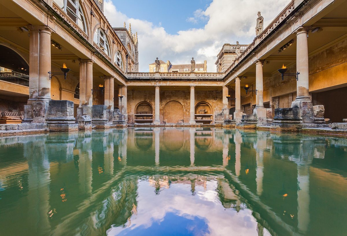 The Great Bath at the Roman Baths, the centrepiece of any Bath travel guide, with Bath Abbey rising behind