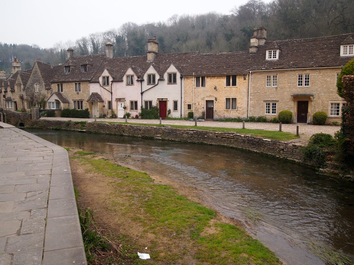 The stone cottages and market cross of Castle Combe, often called the prettiest village in England
