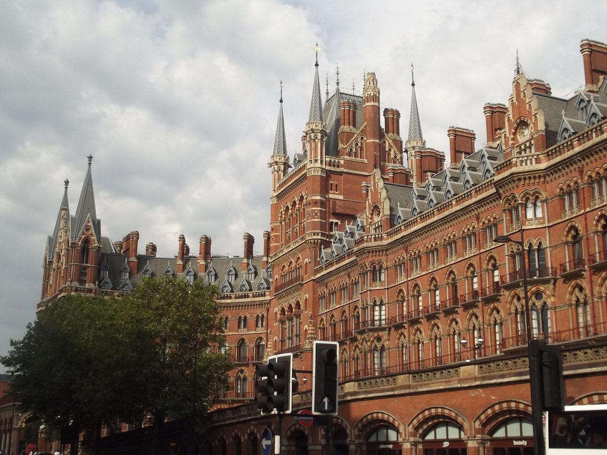 Arrivals checking accommodation apps beneath the roof of St Pancras International station
