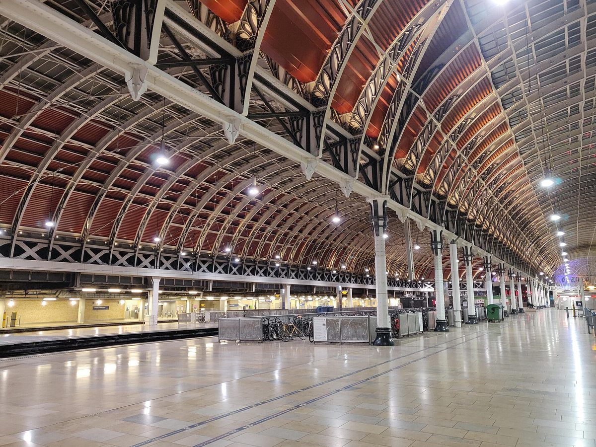 A visitor consulting travel apps on the platform at Paddington station in London