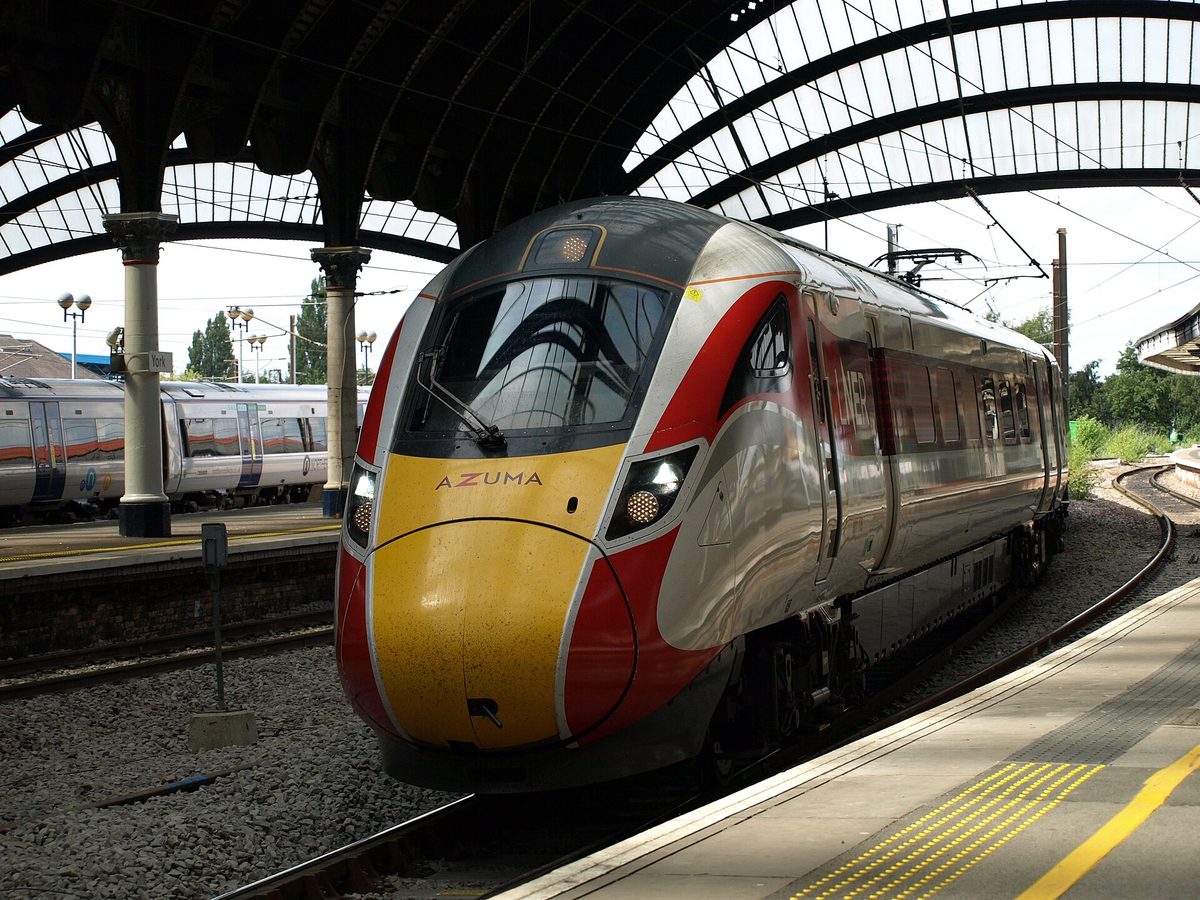 An LNER train at a UK platform, the kind of long-distance service at the heart of the BritRail pass vs train tickets decision