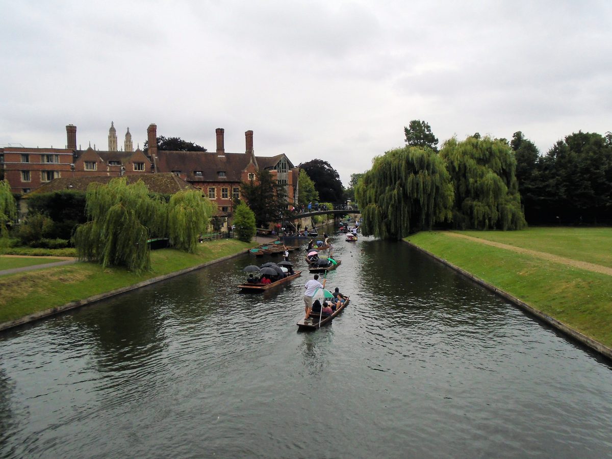 A traditional punt gliding past the colleges on the River Cam in Cambridge