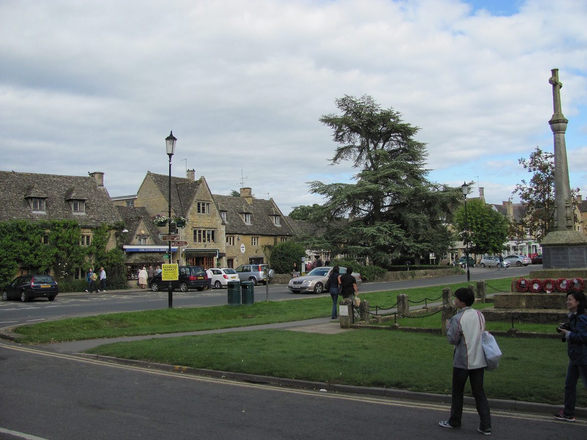Low stone bridges over the River Windrush in Bourton-on-the-Water, a popular Cotswolds day trip stop