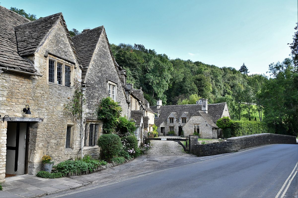 The honey-stone main street of Castle Combe, reachable on a self-drive Cotswolds day trip from London