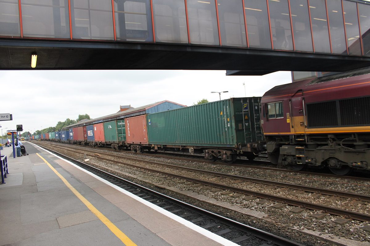 A Cotswold Line train running through green Cotswold countryside between Oxford and Worcester