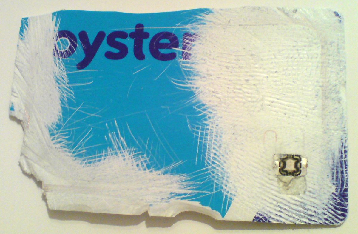 England travel passes: a blue London Oyster card held in front of an Underground roundel