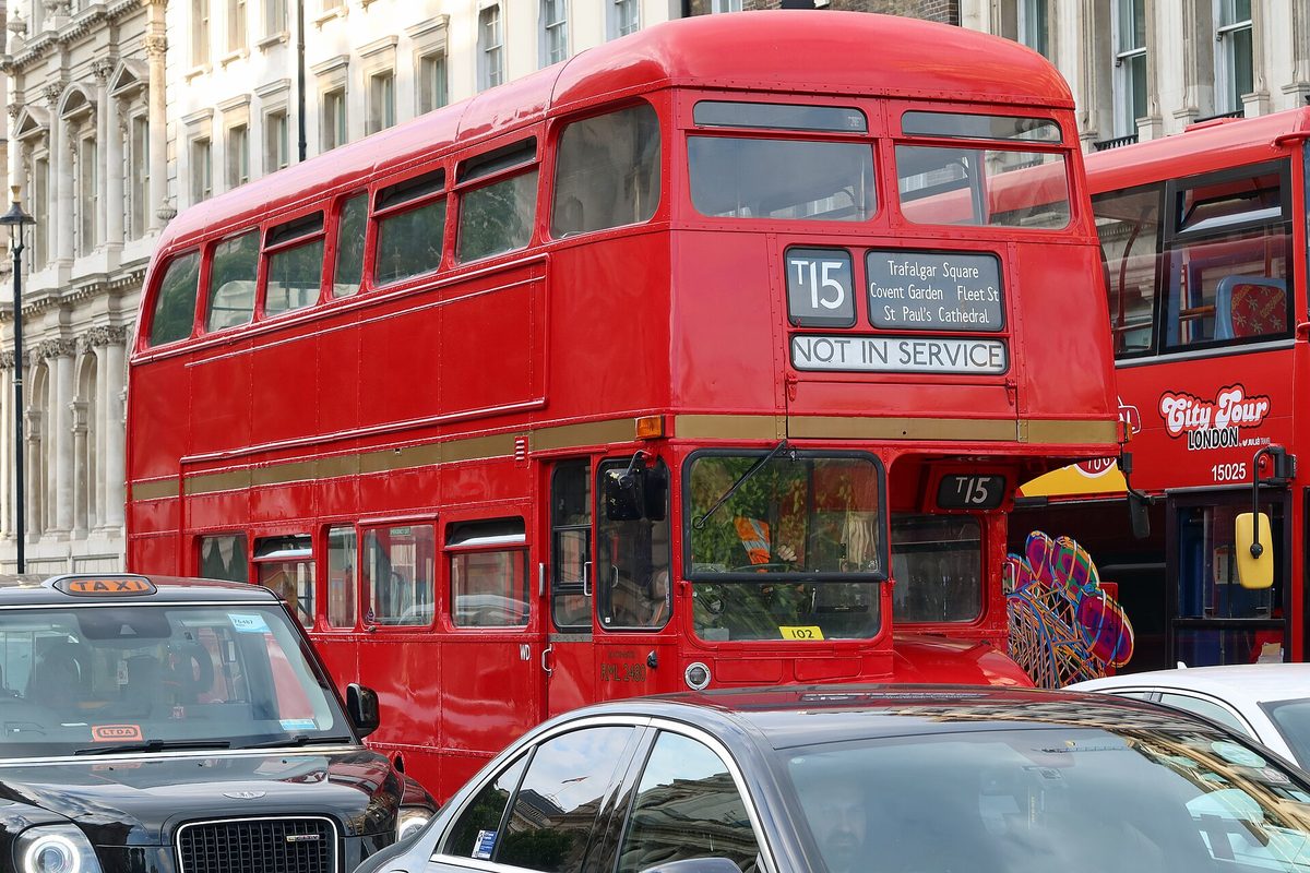 Tapping a contactless card to pay on an England bus, where a £3 single-fare cap applies