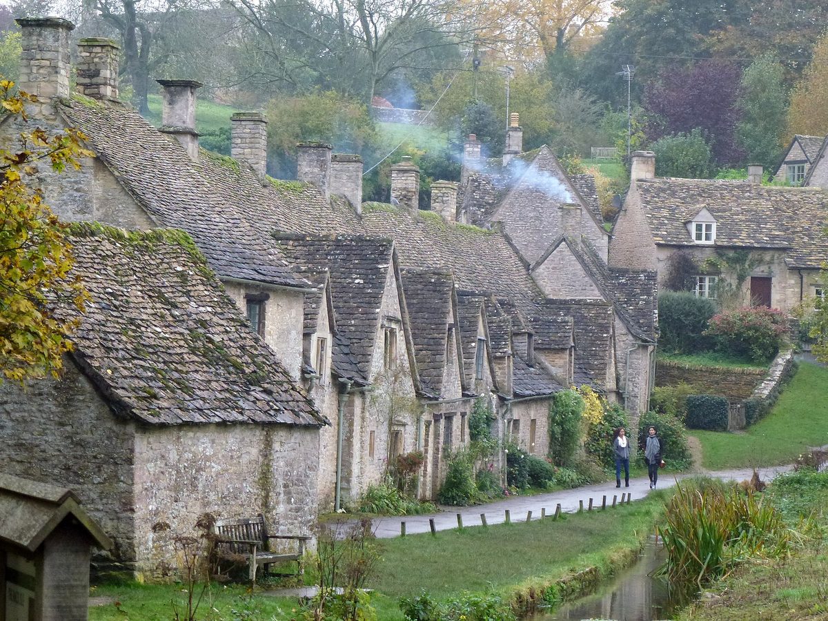 Honey-coloured stone cottages at Arlington Row in Bibury, the Cotswolds, a classic rural England scene