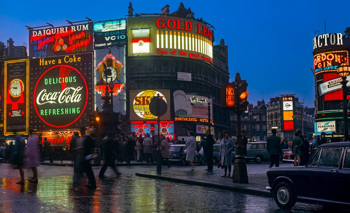 The bright lights of Piccadilly Circus at dusk — central London stays busy and well-lit well into the evening.