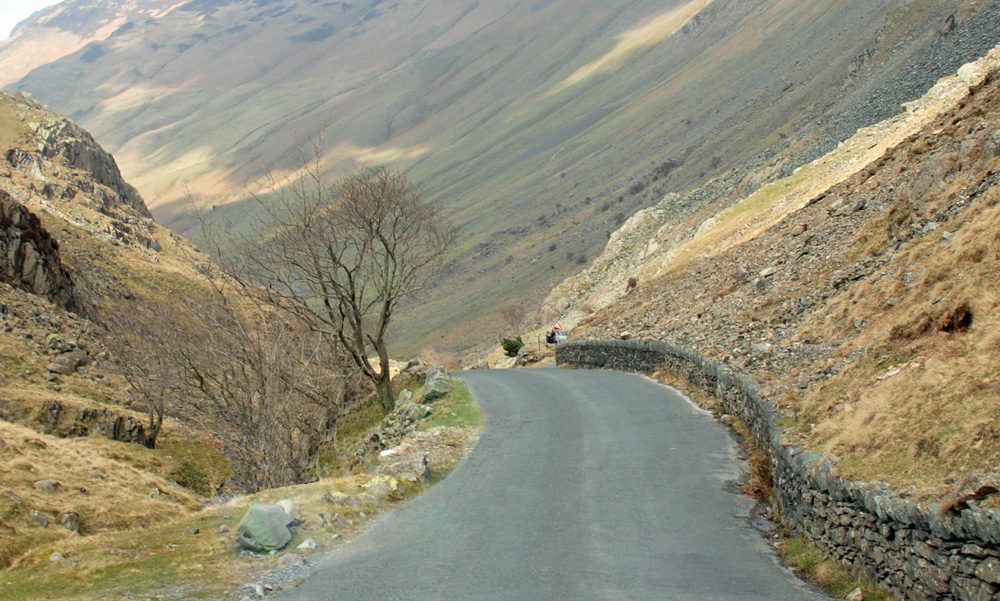 Rain and low cloud sweeping over the dramatic Honister Pass, one of the most atmospheric Lake District rainy day activities is simply driving its high road