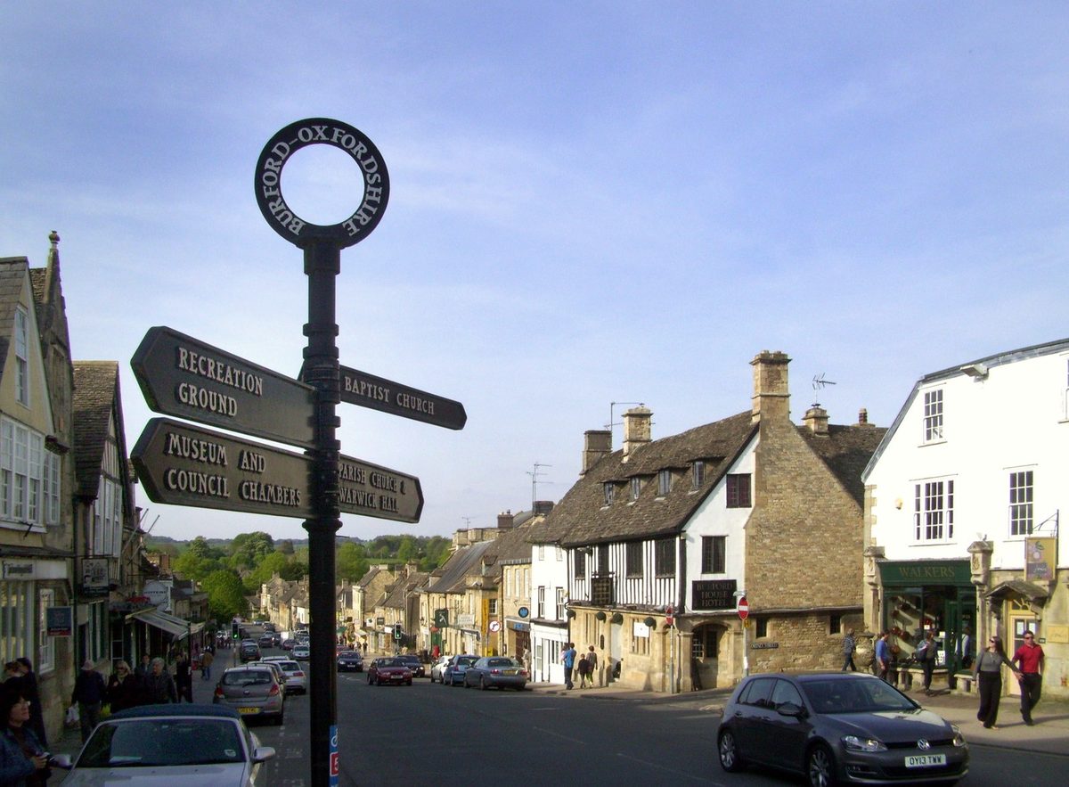 The sloping medieval Burford High Street, the eastern gateway base in the Cotswolds